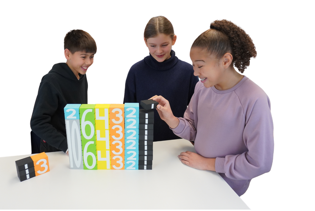 Students learning with Math Stackers on a table
