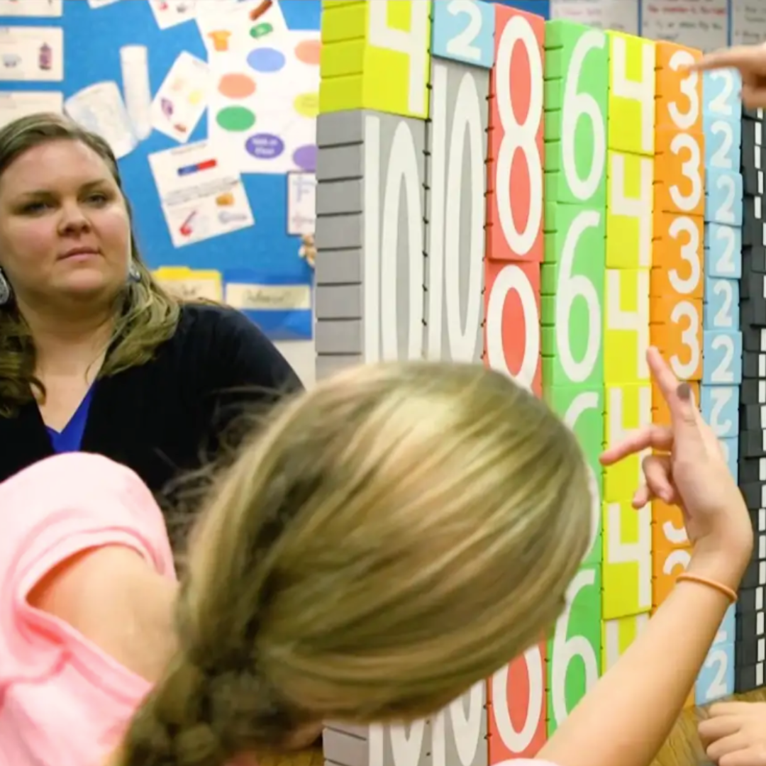 Teacher and student interacting with Math Stackers in a classroom setting